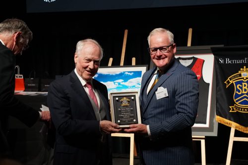 Terry Tobin KC (left) receives his award from Principal Dr Michael Davies.