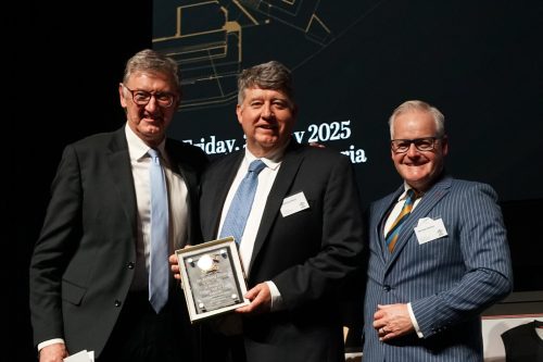 Dr Anthony Slavin (middle) receives his award from Principal Dr Michael Davies (right) and MC Simon Madden (left).